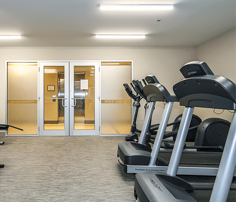 A gym with treadmills and a sign that says "moonwalk".