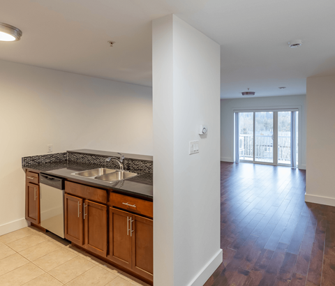 A kitchen with a sink and a counter top.