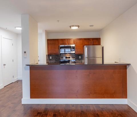 A kitchen with a wooden counter and stainless steel appliances.