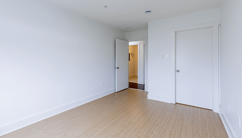 A room with a wooden floor and white walls.