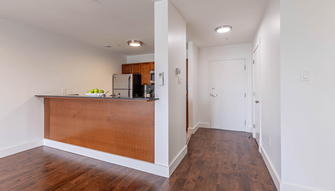 A kitchen with a wooden counter and a refrigerator.