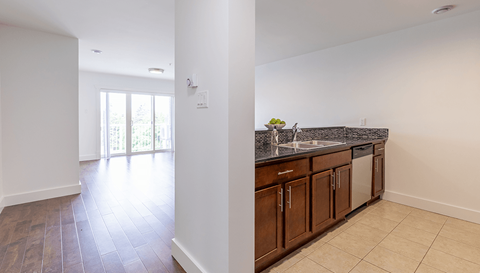 A kitchen with brown cabinets and a counter top.