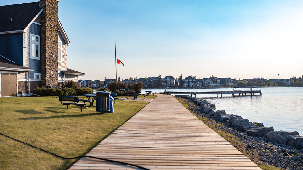a boardwalk with a house and a dock on the water