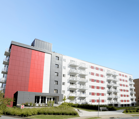 A modern building with a red and white facade.