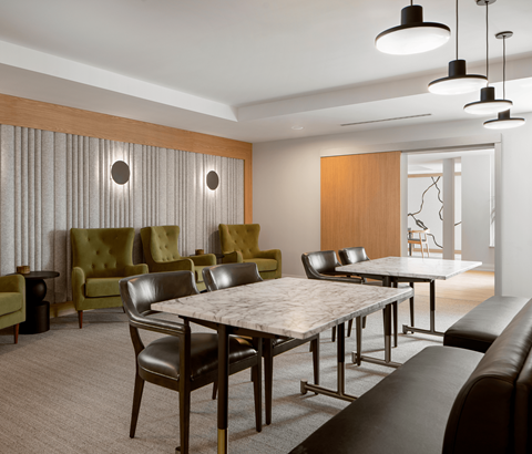 A modern dining room with a large table and chairs.
