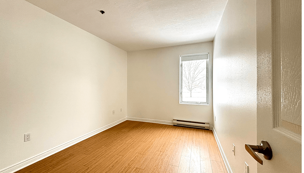 A room with a window and a door.