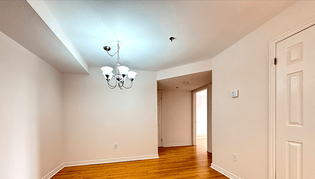A room with a chandelier and a door.