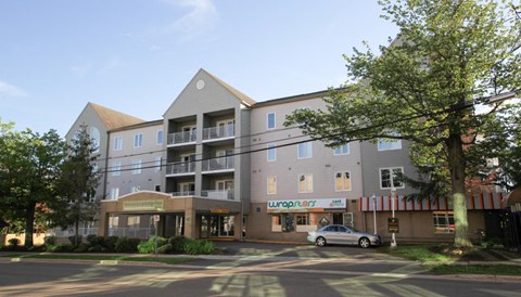an apartment building with a car parked in front of it