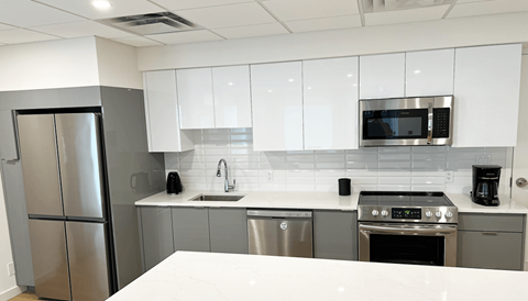 a kitchen with stainless steel appliances and white cabinets