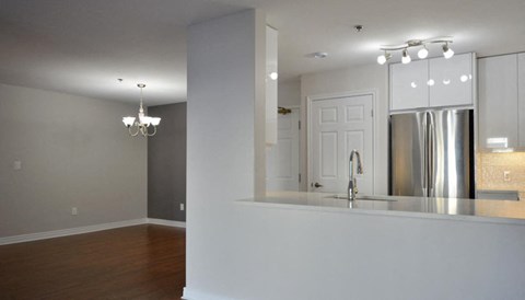 an empty kitchen with a sink and a refrigerator