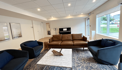 a living room with a couch and chairs and a fireplace