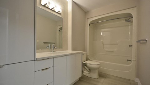 a bathroom with a toilet and a sink and a shower