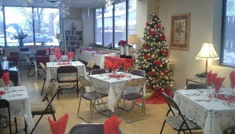 a dining room with tables and a christmas tree