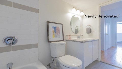 a white bathroom with a toilet and a sink