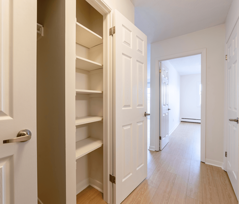 A white door is open to a hallway.