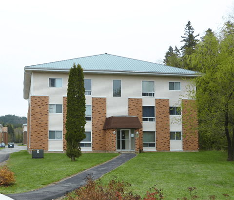 A large building with a green roof and a brick facade.