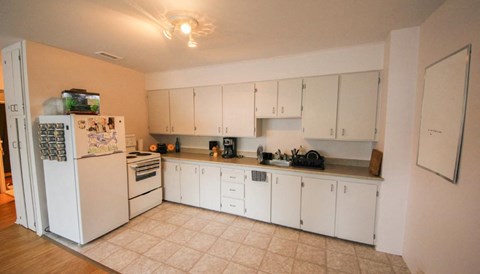 a kitchen with white appliances and white cabinets