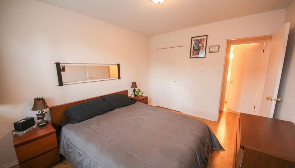 a bedroom with a bed and a mirror