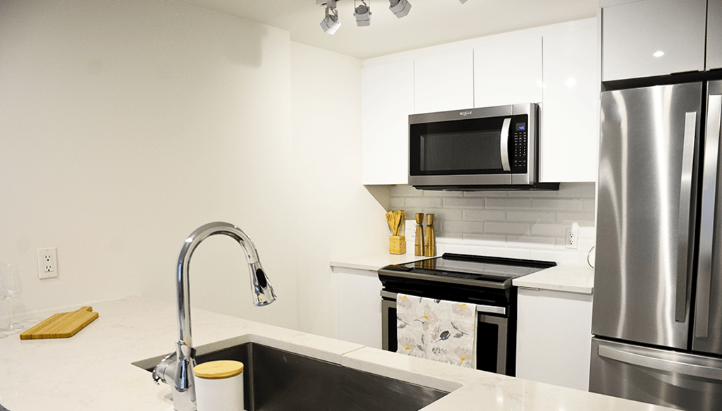 A modern kitchen with a black and white color scheme.
