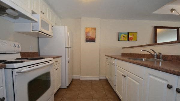 a kitchen with a stove refrigerator and a sink