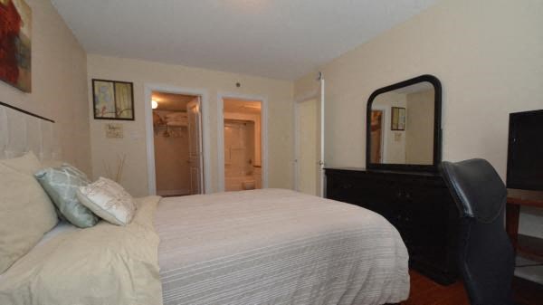 a bedroom with a large bed and a mirror