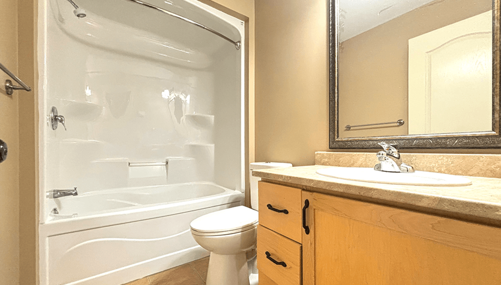 A bathroom with a toilet, sink, and bathtub.