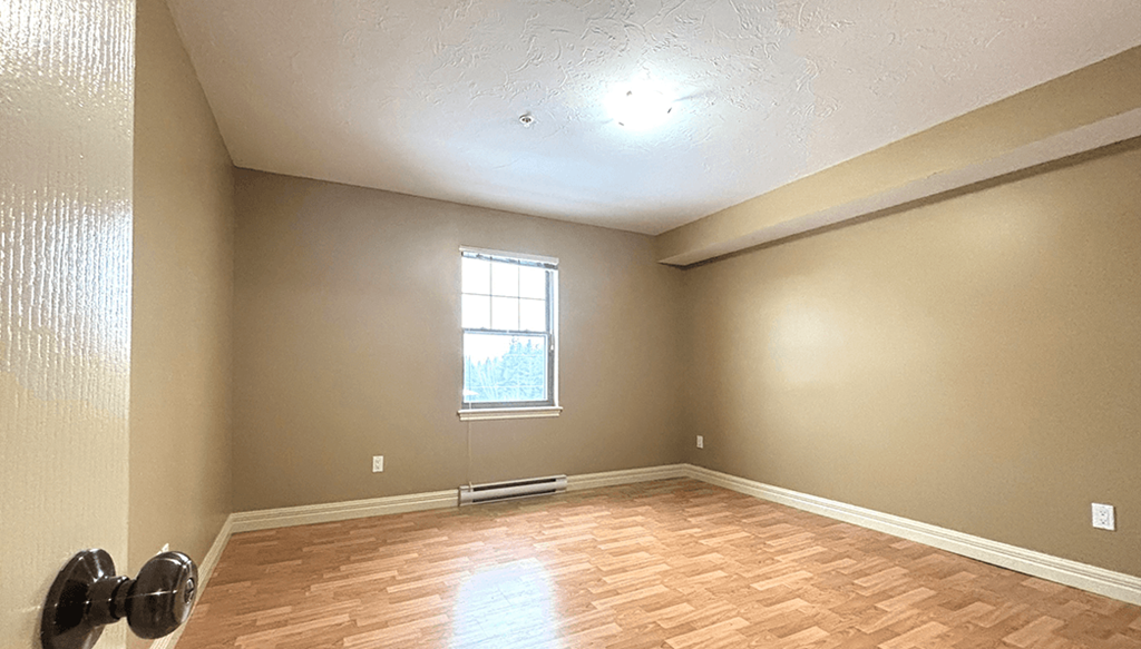 A room with a window and a door.