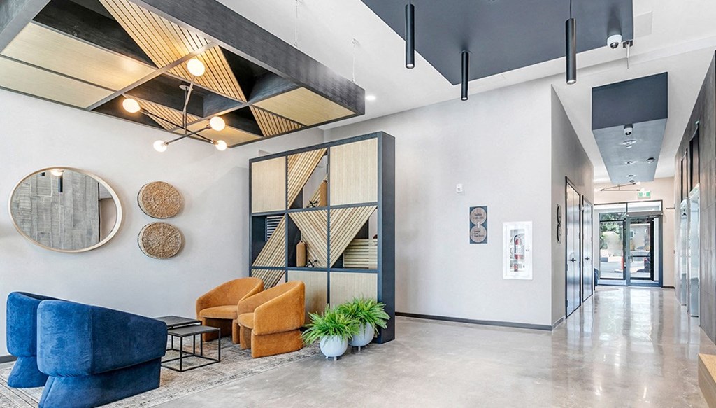 a lobby with couches and chairs and a glass door