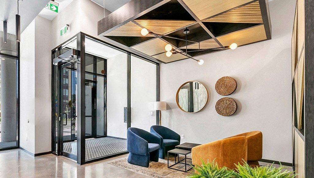 a lobby with furniture and a large glass door