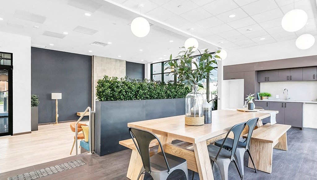 a dining room with a wooden table and black chairs