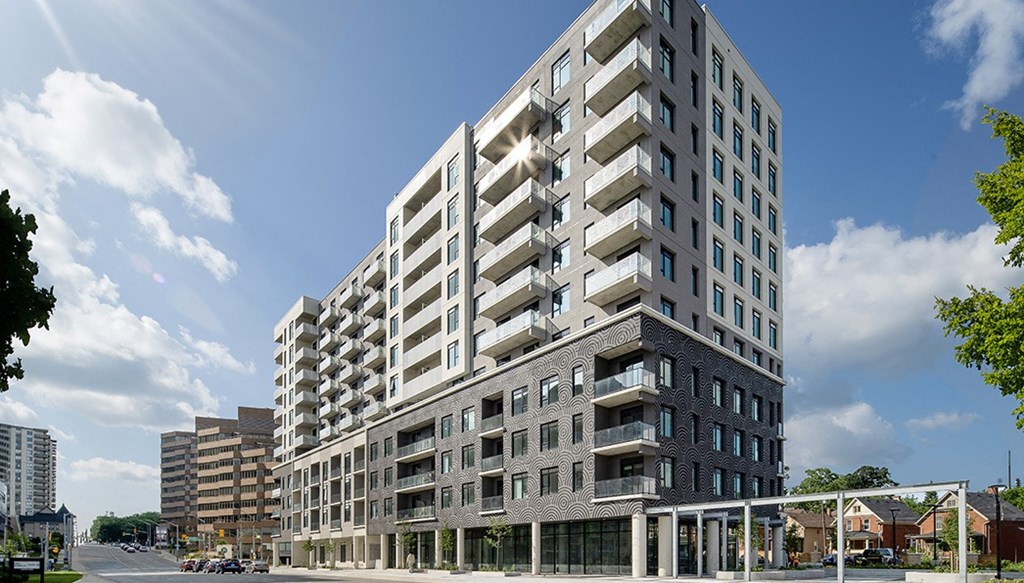 a large building with many windows and a street in front of it