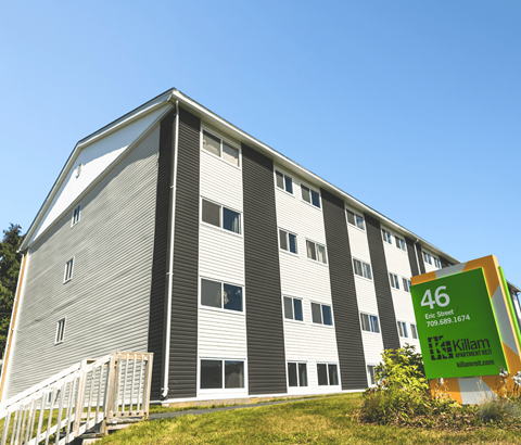 A large building with the number 46 on a sign in front of it.
