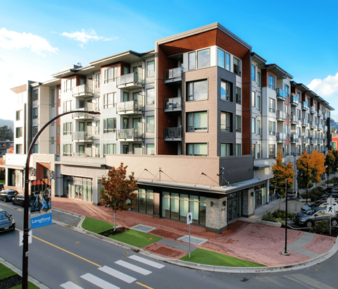 A modern apartment building with a street in front.