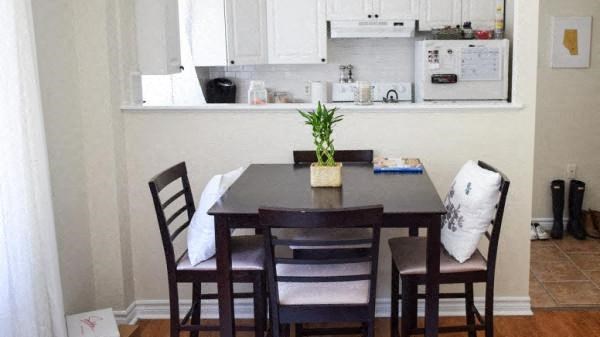 a dining room table with chairs and a plant on it
