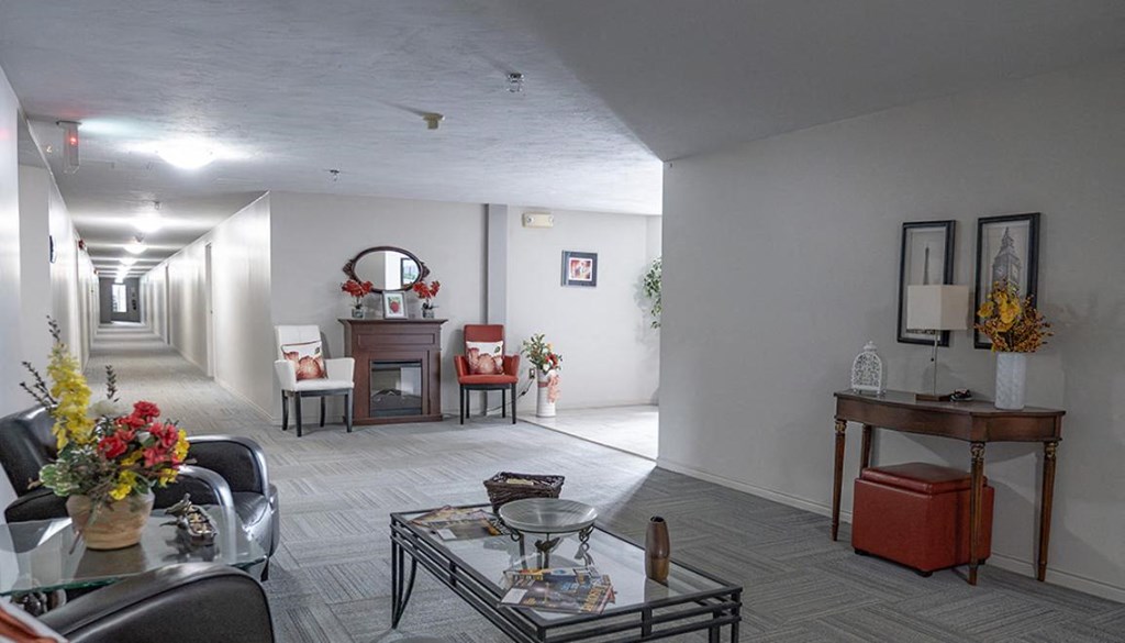 A living room with a glass table and chairs.