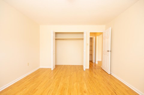 a empty room with wood floors and a closet