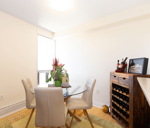 A dining room with a glass table and chairs.