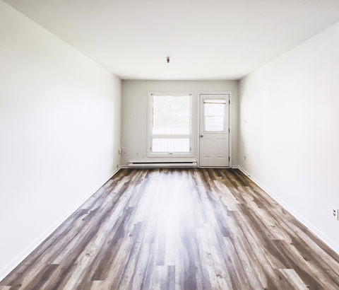 A room with a wooden floor and white walls.