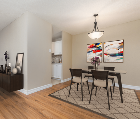 A dining room with a table set for four.