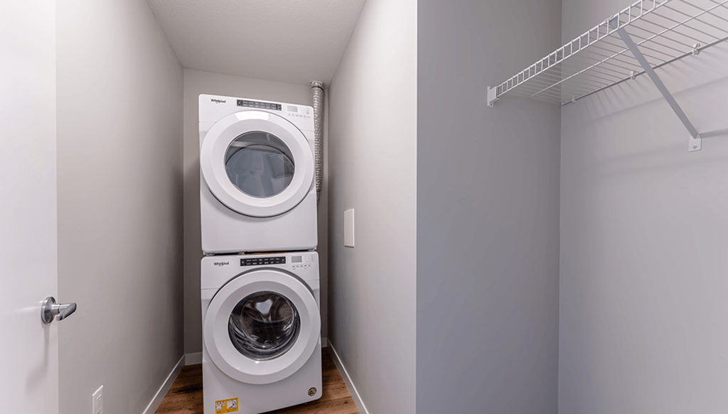 A white washing machine and dryer in a small laundry room.