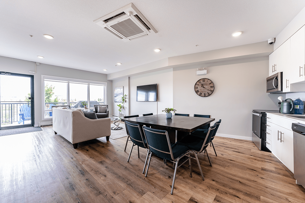 A modern kitchen with a dining table and chairs.