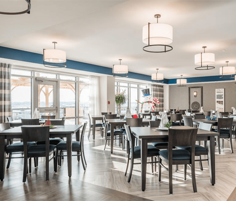 A modern dining room with a large table and chairs.
