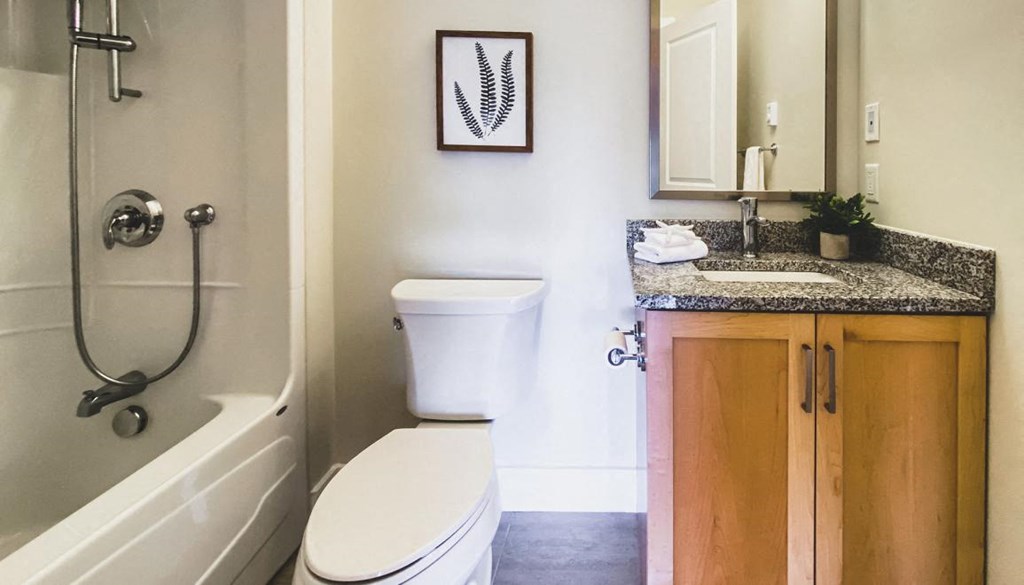 A bathroom with a toilet, sink, and bathtub.
