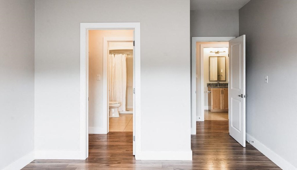 A white room with a doorway leading to another room.