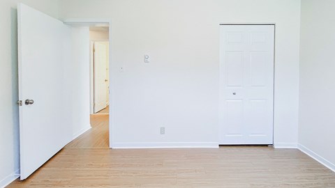 A white door is on the left and a white door with a window is on the right.