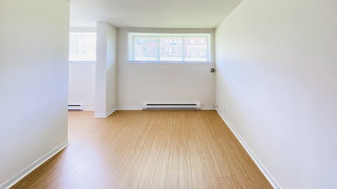 A room with wooden floors and a window.