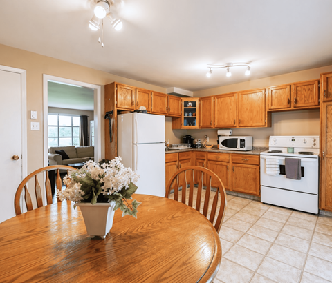 A kitchen with wooden cabinets and white appliances.