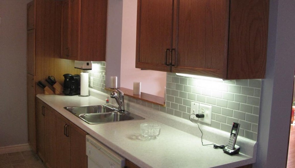 A kitchen with wooden cabinets and a white countertop.