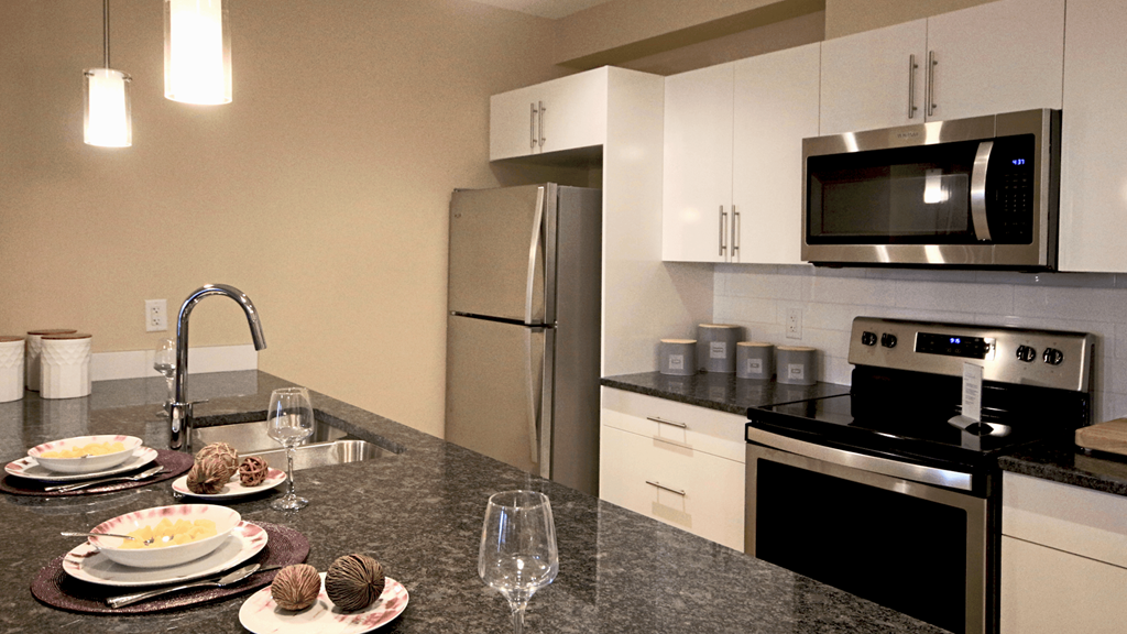 a kitchen with granite counter tops and stainless steel appliances