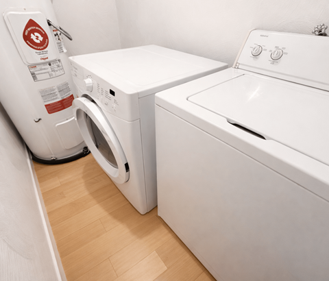 A white washing machine and dryer in a small laundry room.